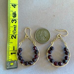 Handmade earrings in gold filled wire and garnet beads.
